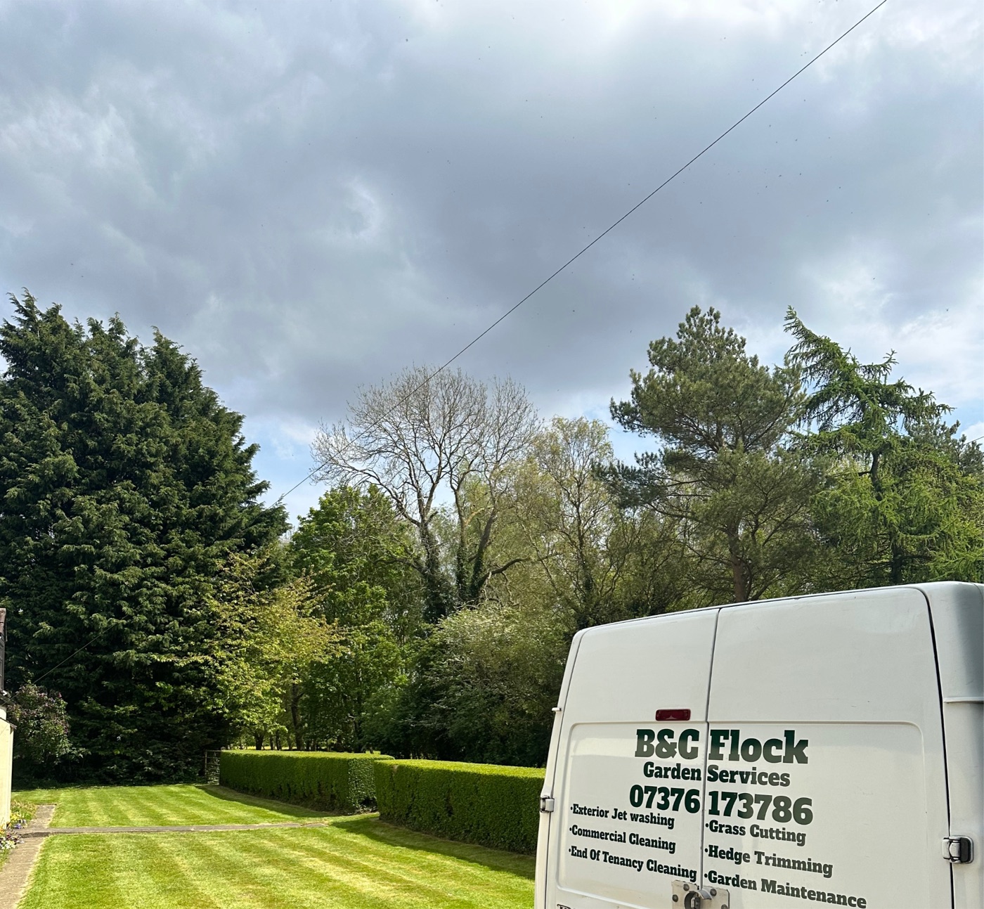 The B and C Flock van parked beside a freshly striped lawn and trimmed hedge